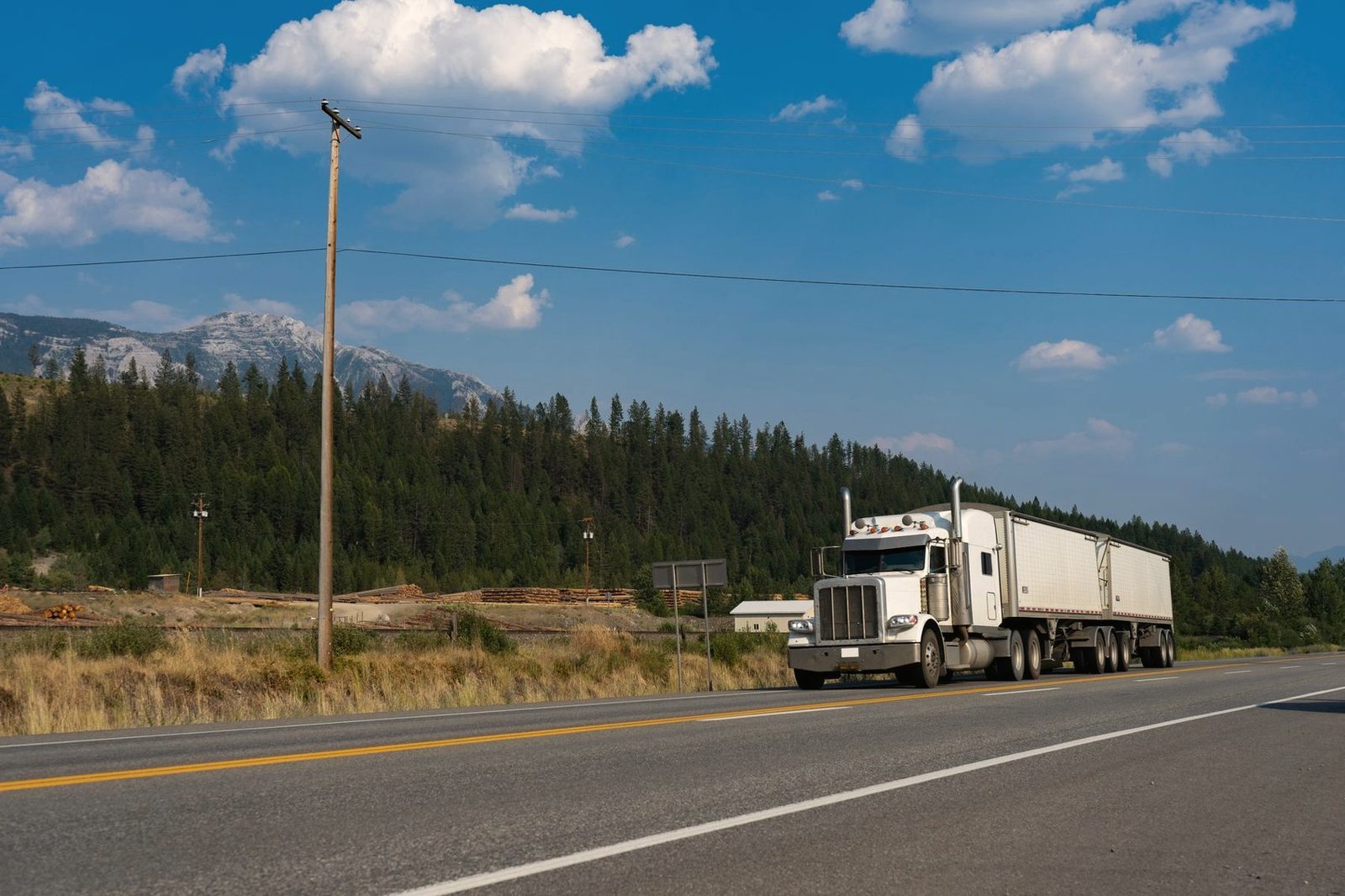 Semi truck on a two-lane highway through open country